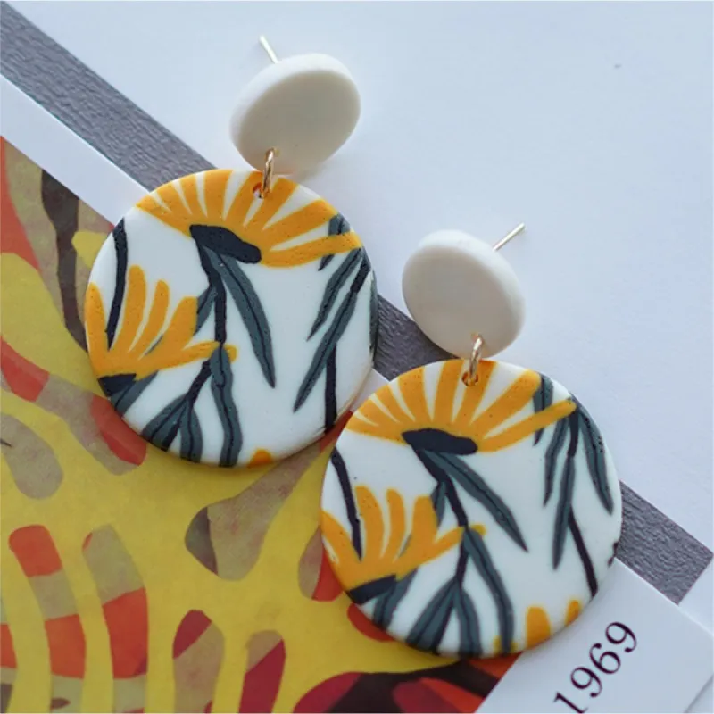White & Yellow Flower Circular Clay Earrings sold by Zulily