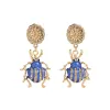 Goldtone Flower & Blue Beetle Drop Earrings sold by Zulily