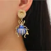 Goldtone Flower & Blue Beetle Drop Earrings sold by Zulily