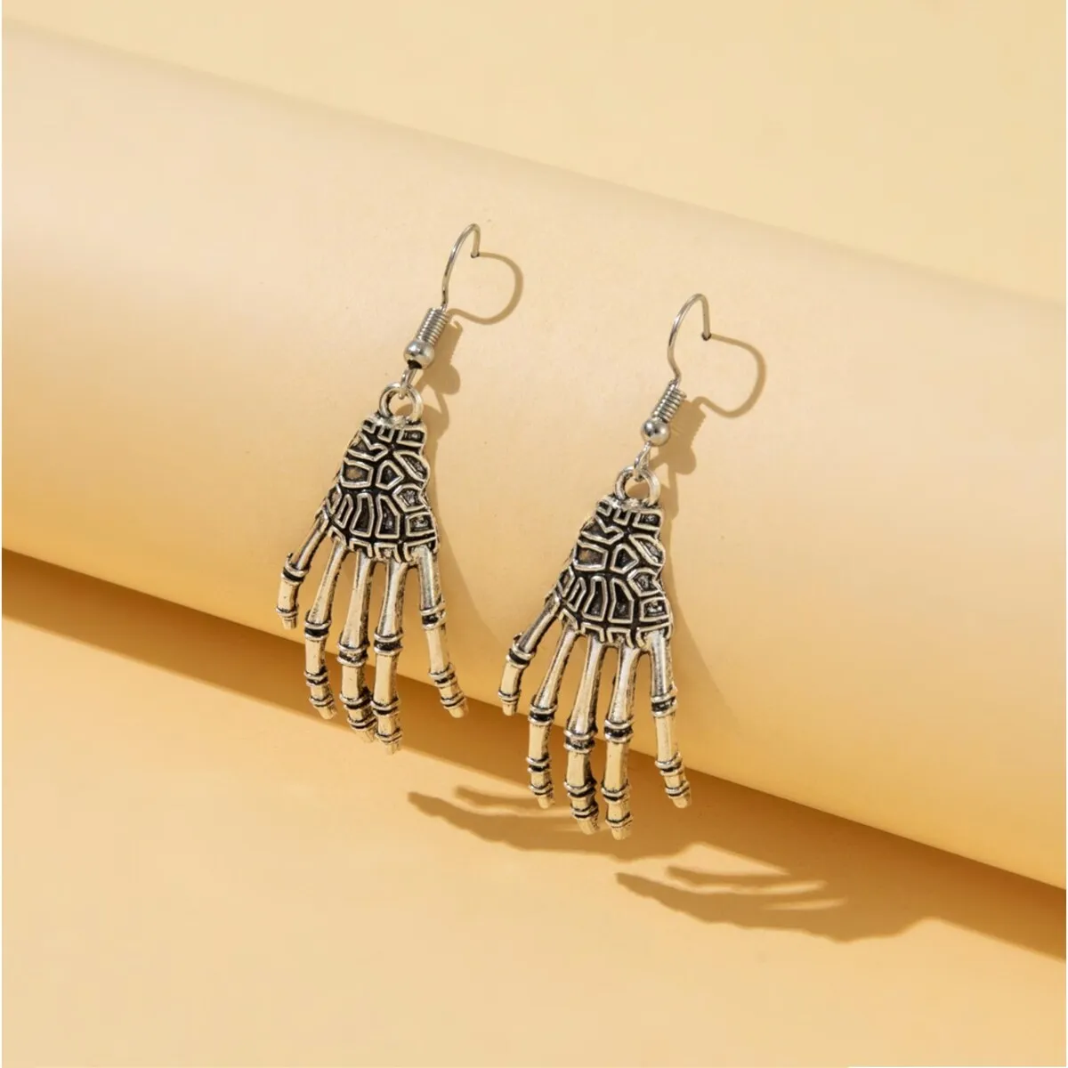 Silvertone Skull Hands Drop Earrings sold by Zulily