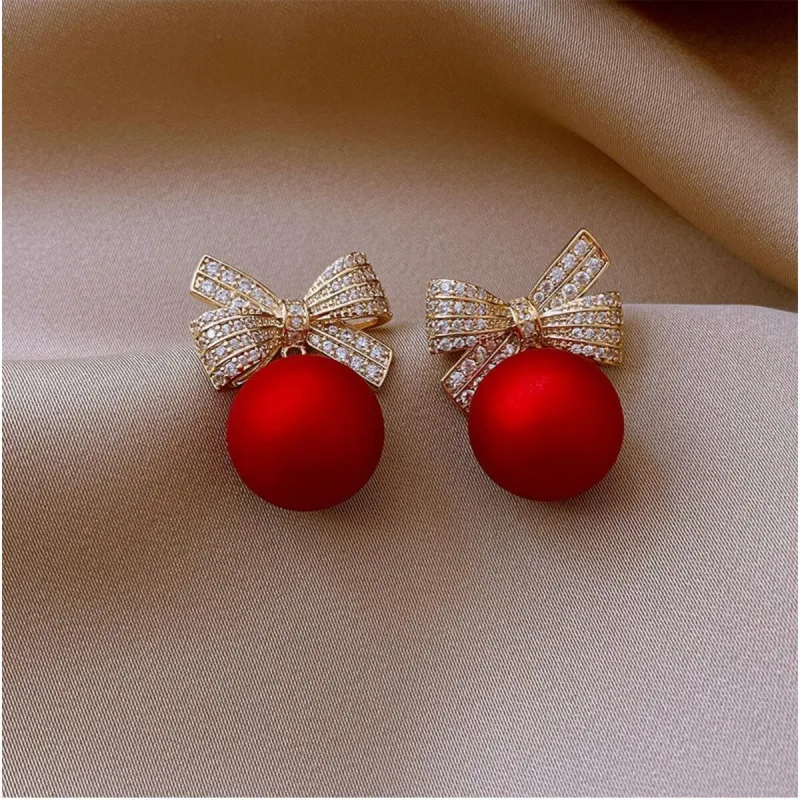 Red Imitation Pearl Crystal Bow Stud Earrings sold by Zulily