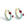 Goldtone Blue Huggie Hoop Earrings With Red Crystals sold by Zulily