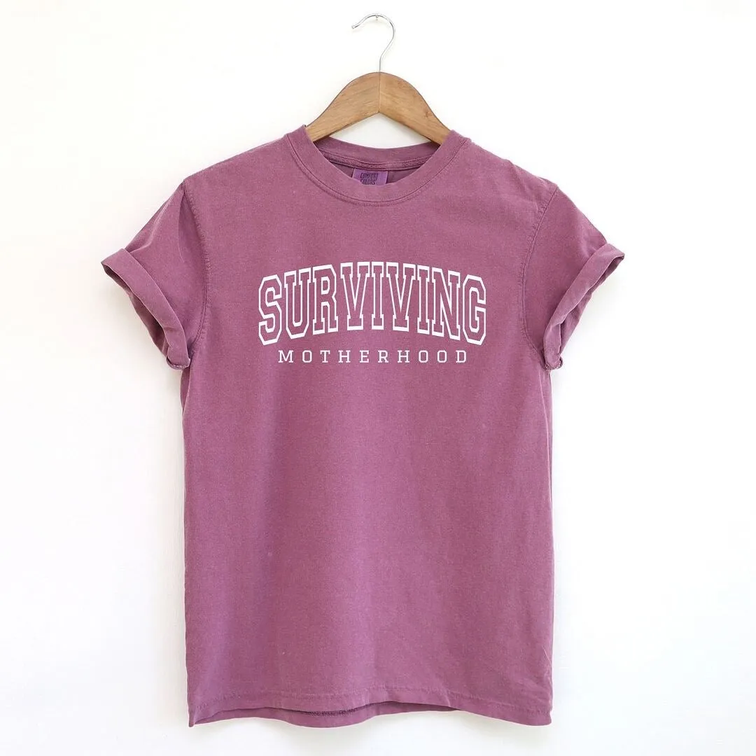Varsity Surviving Motherhood Garment Dyed Tee sold by Zulily