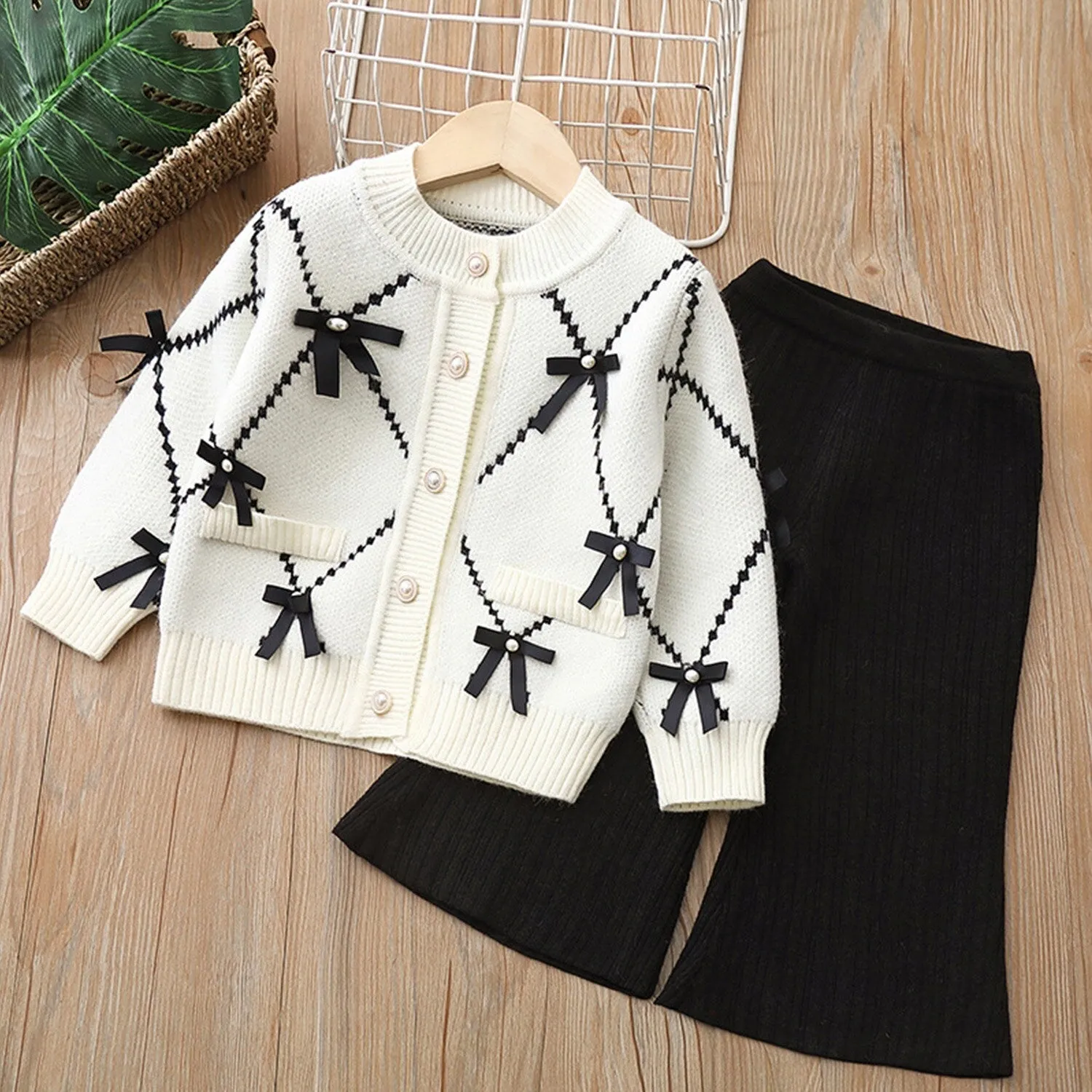 White & Black Bow Knitted Cardigan Suit sold by Zulily