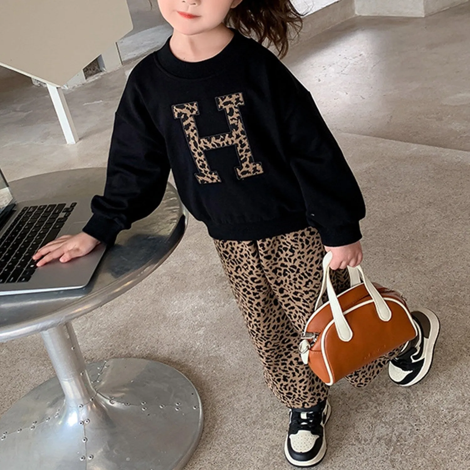 Black & Brown Leopard "H" Round Neck Long-Sleeve Top & Leopard Wide-Leg Pants sold by Zulily
