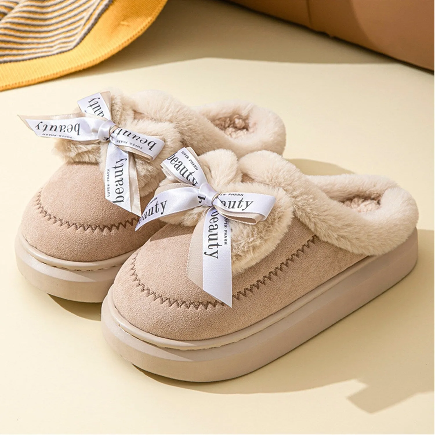 Beige Bow Plush Slippers sold by Zulily