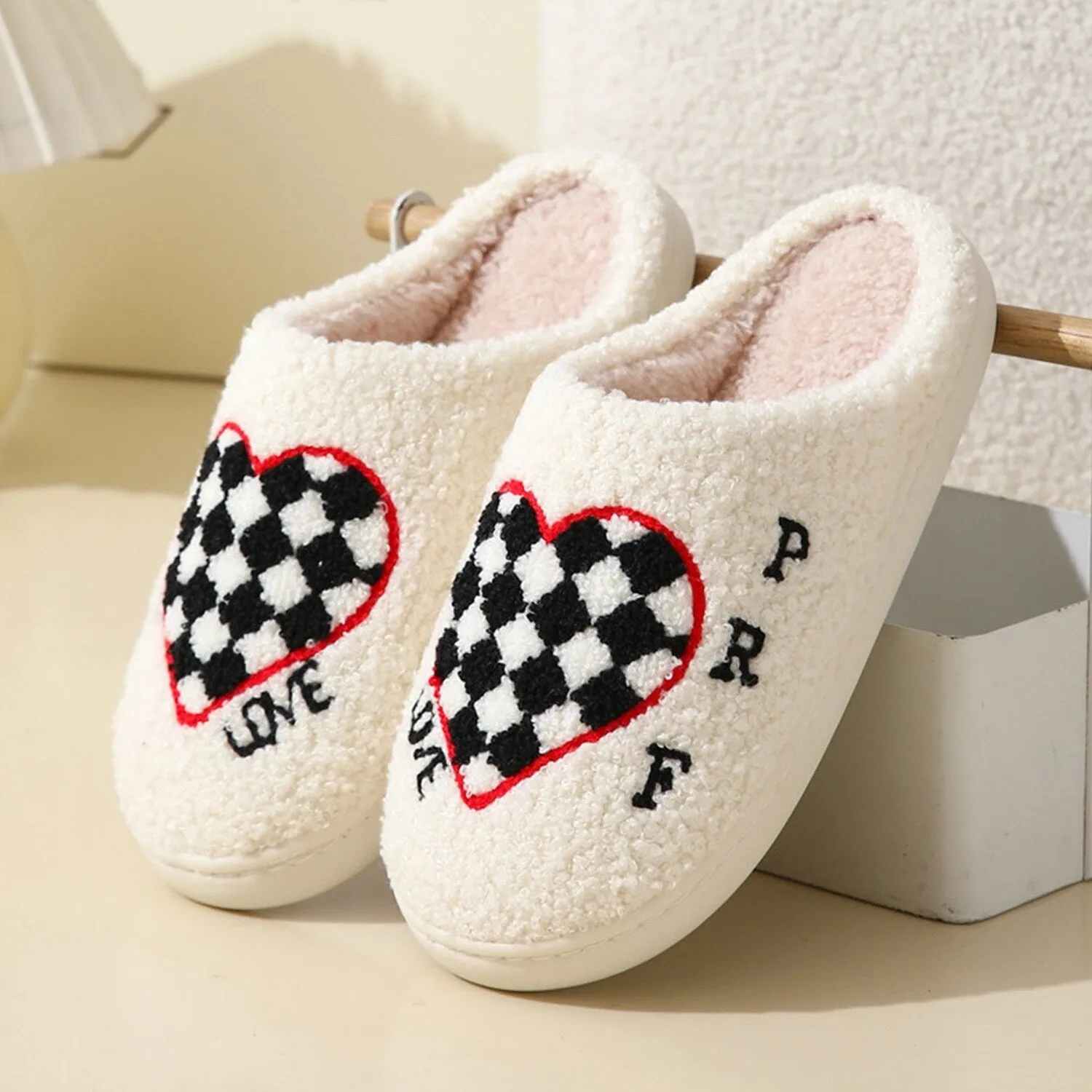 White & Black Checkerboard Heart Plush Slippers sold by Zulily