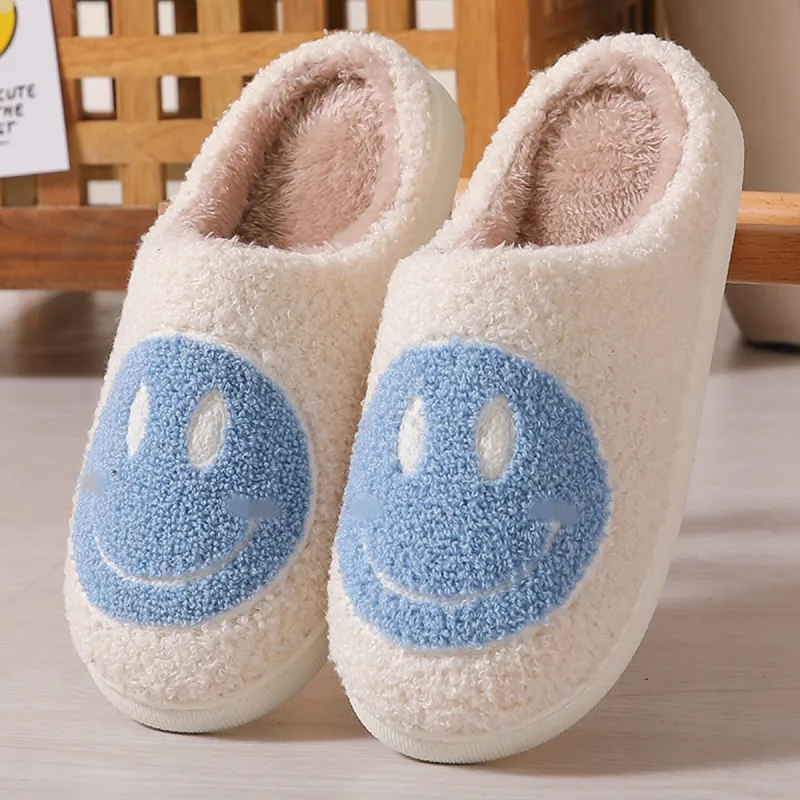 White & Blue Smiley Face Plush Slippers sold by Zulily