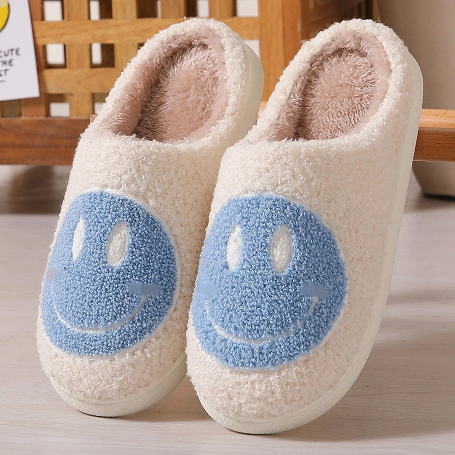 White & Blue Smiley Face Plush Slippers sold by Zulily