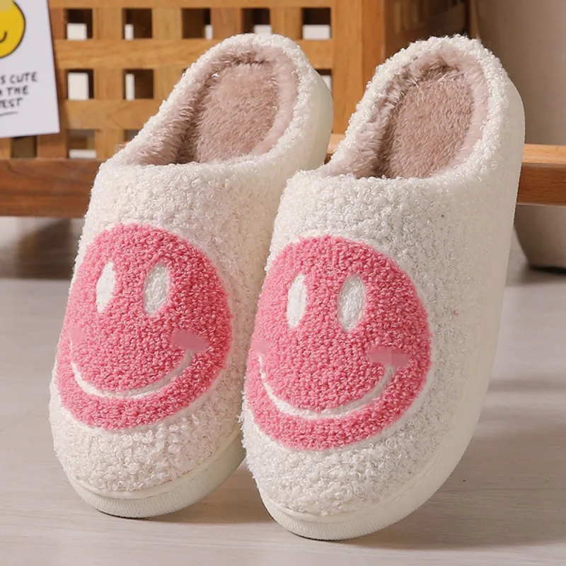 White & Pink Happy Face Plush Slippers sold by Zulily