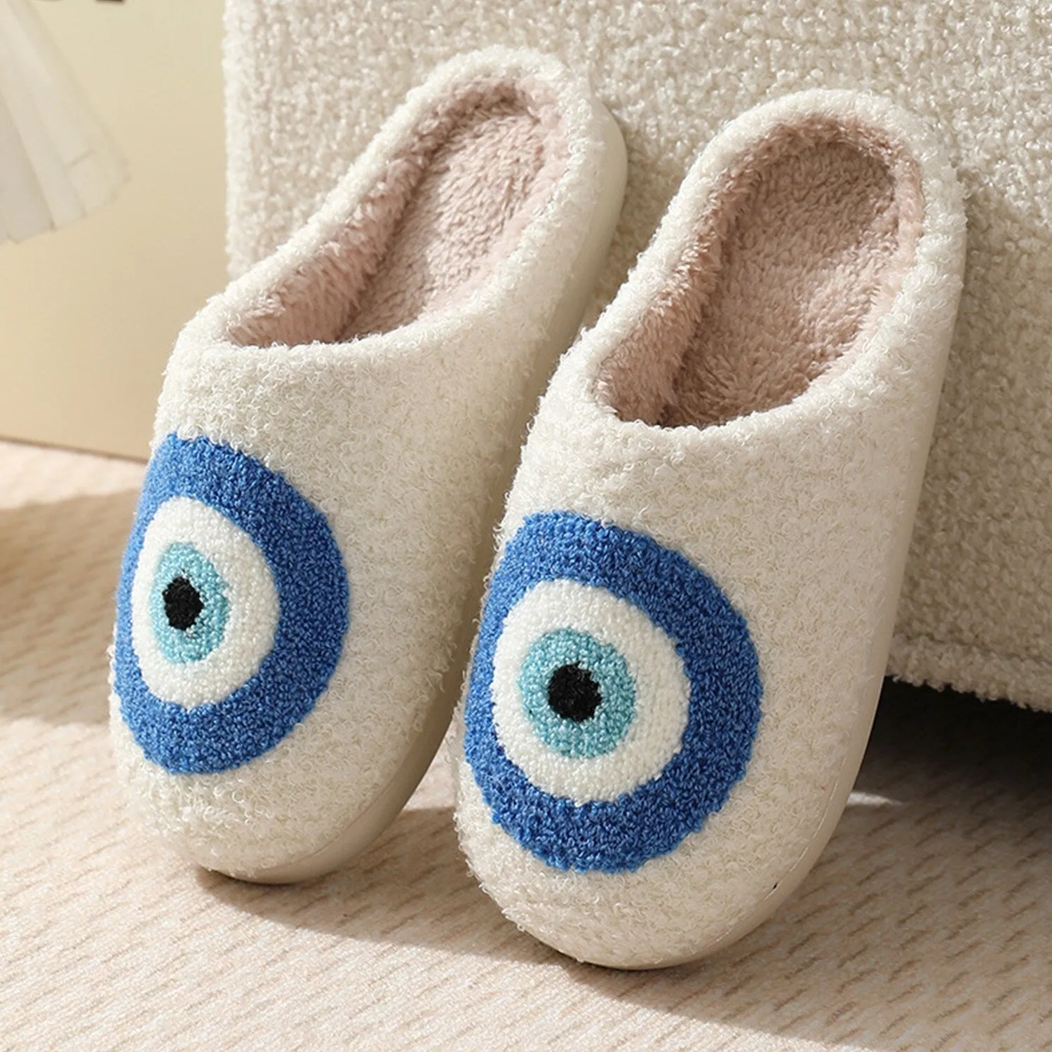 White & Blue Circle Plush Slippers sold by Zulily