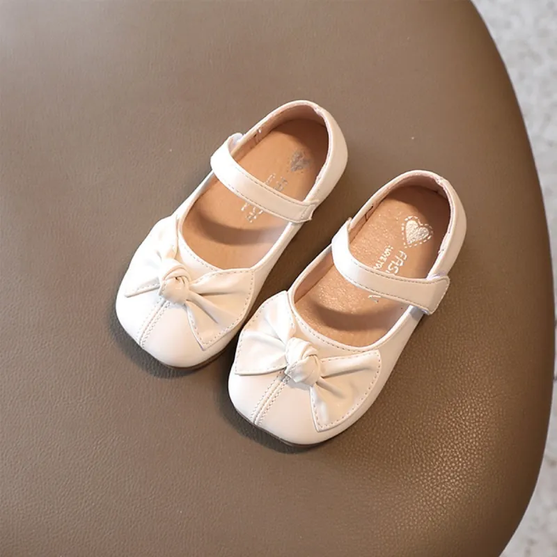 White Bow Girls' Flat Shoes sold by Zulily