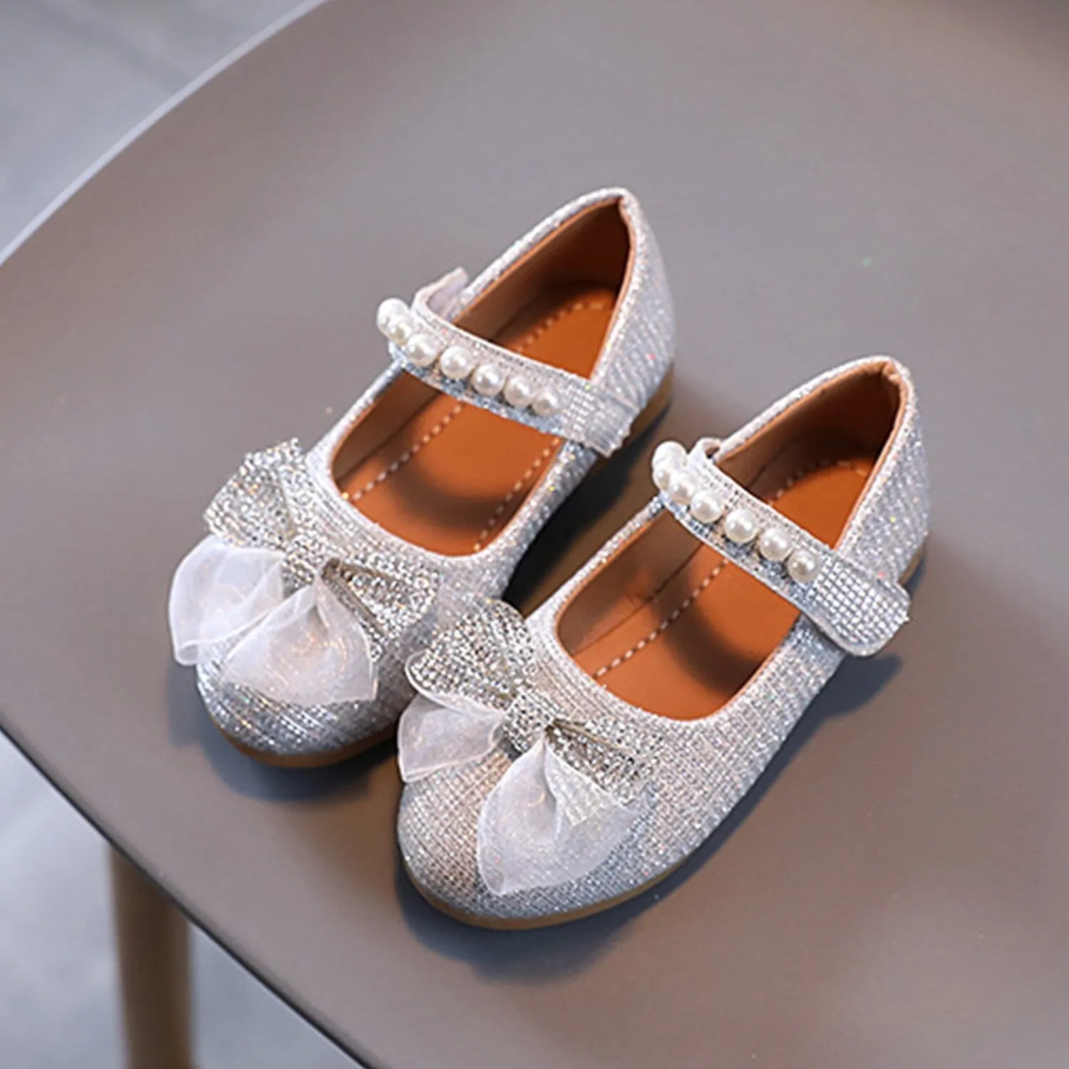 Silver Rhinestone Bow Girls' Flat Shoes sold by Zulily
