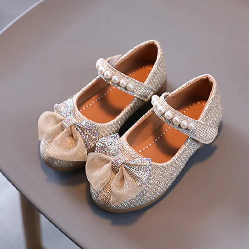 Gold Rhinestone Bow Girls' Flat Shoes sold by Zulily