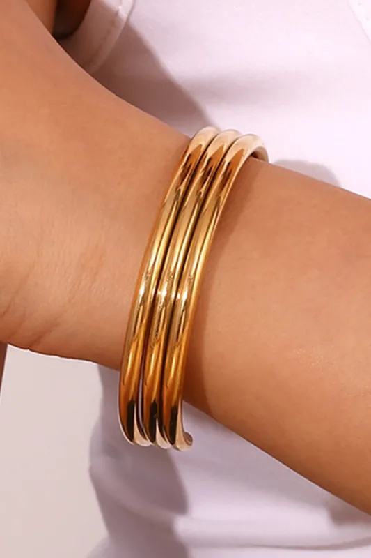 Gold Three Layered Notched Design Bangle by Threaded Pear sold by Zulily