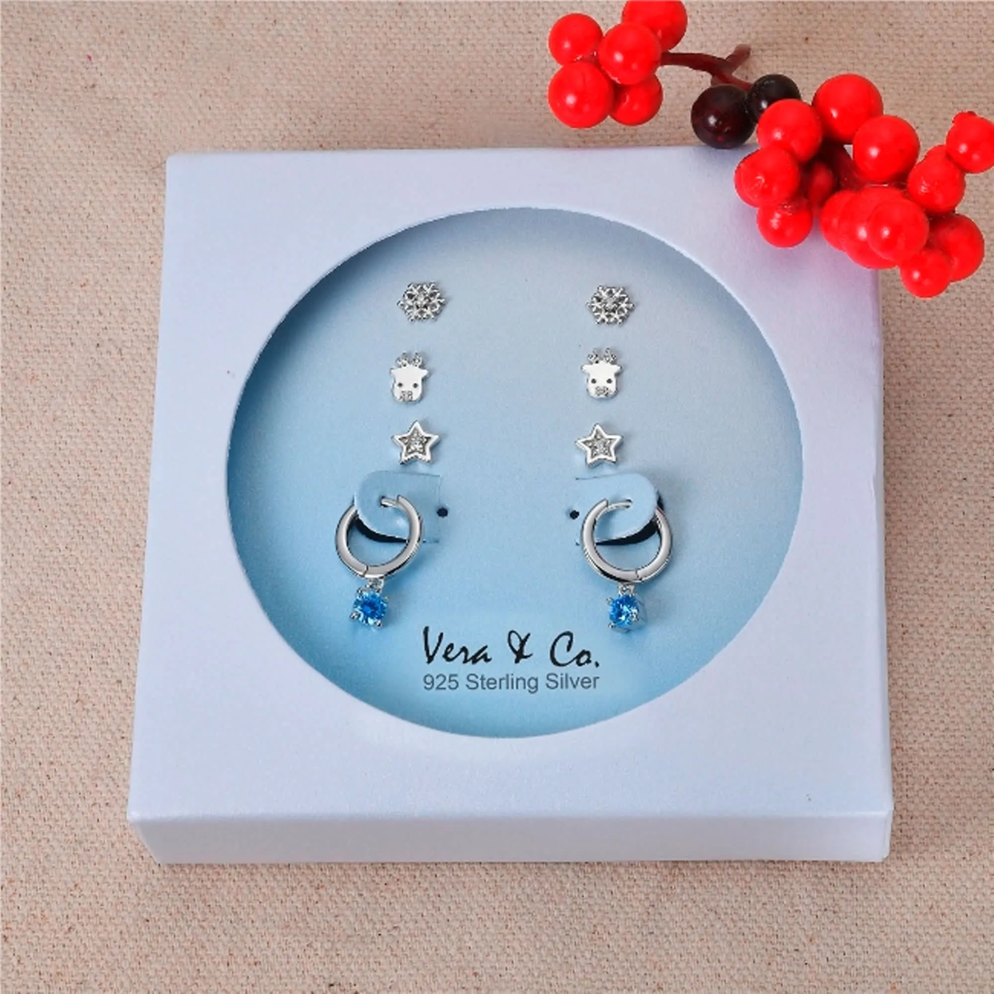 Sterling Silver Holiday 4-Set Earring of CZ Star Stud, Moose Stud, Snowflake Stud, A drop of Blue CZ Huggie sold by Zulily