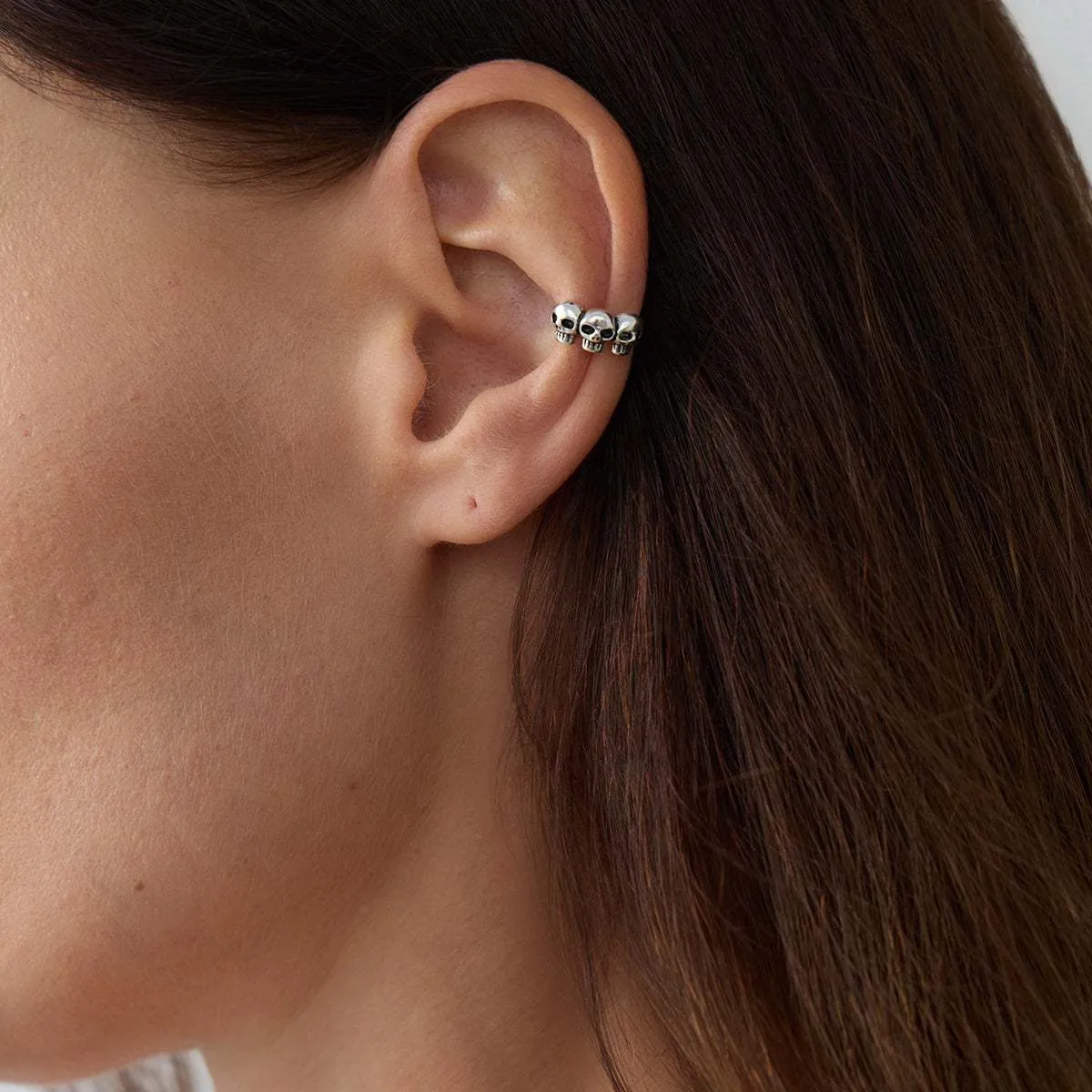 Silvertone Three-Skulls Ear Cuff sold by Zulily