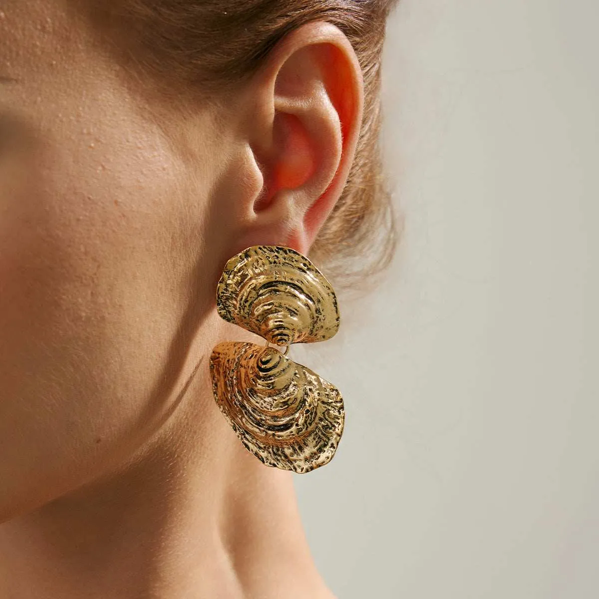 Goldtone Hammered Shell Dangle Earrings sold by Zulily