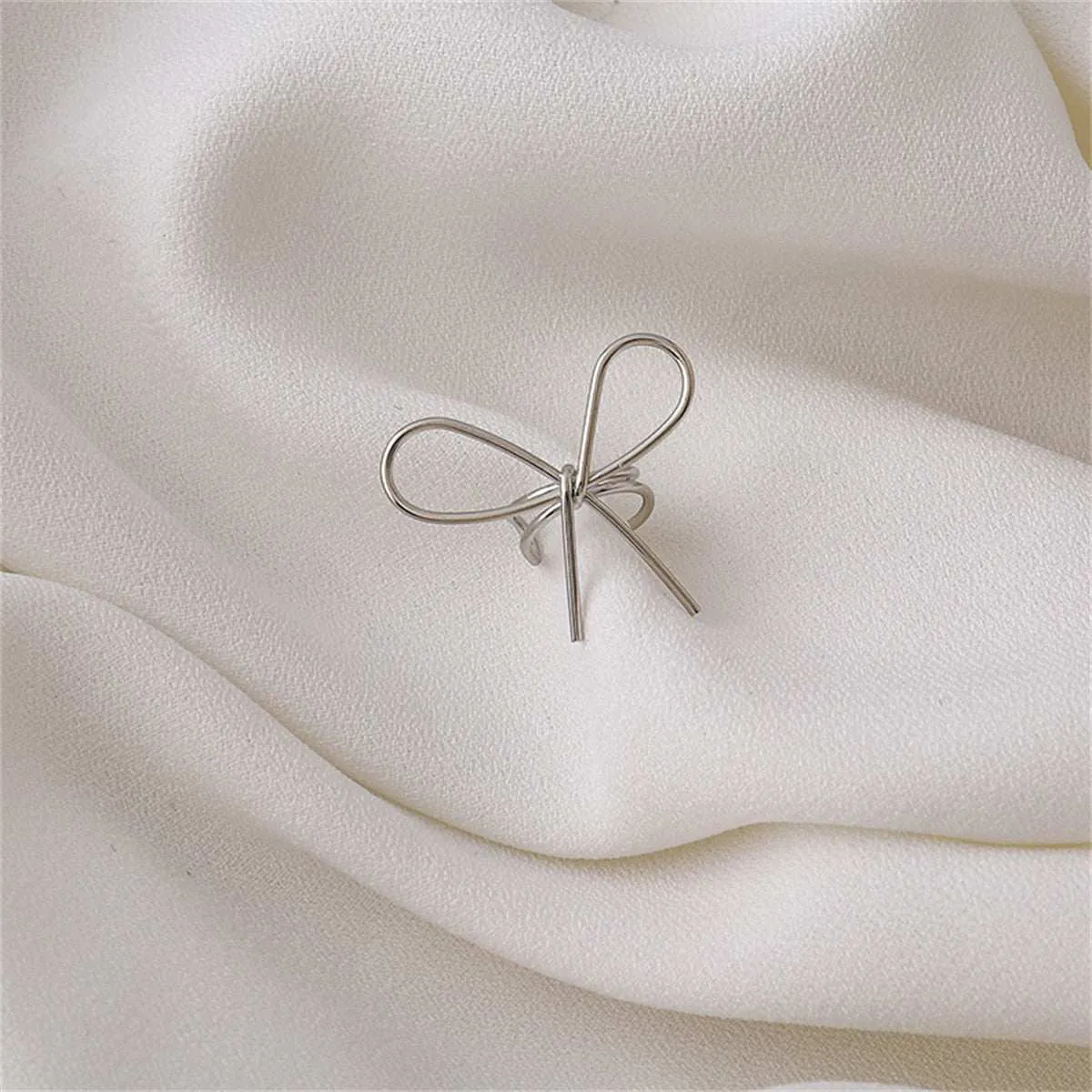 Silvertone Bow Ear Cuff sold by Zulily