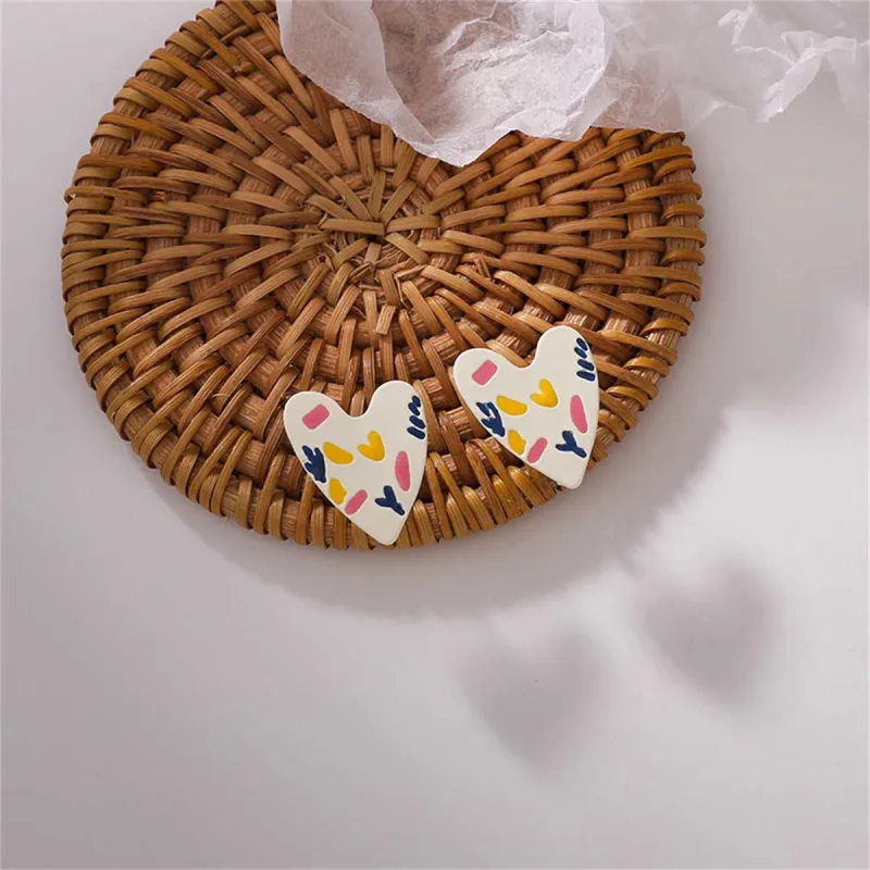 White & Silvertone Heart Stud Earrings made by Zulily