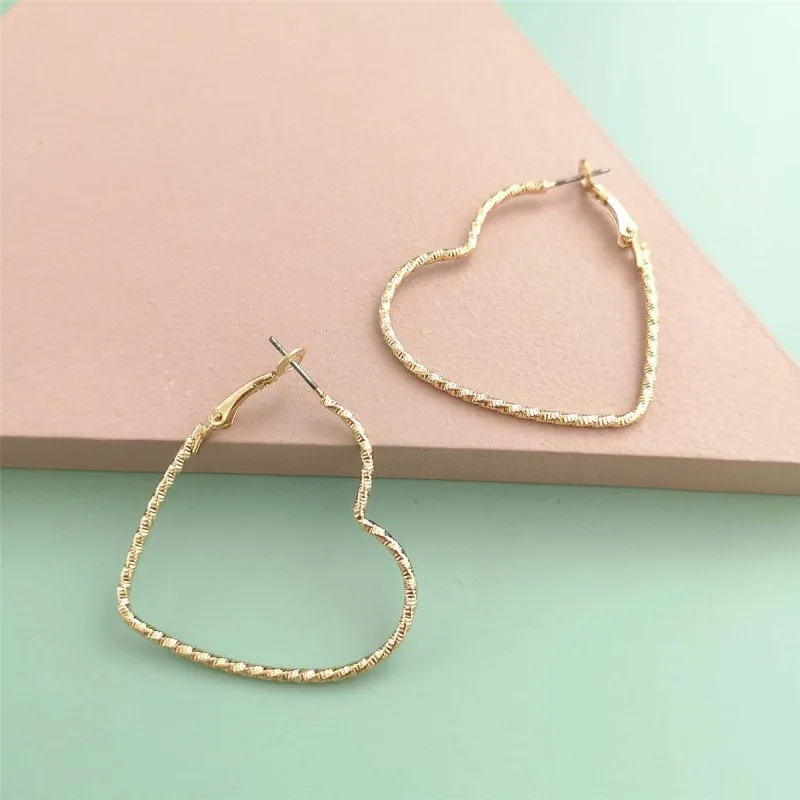 Goldtone Twisted Open Heart Hoop Earrings made by Zulily