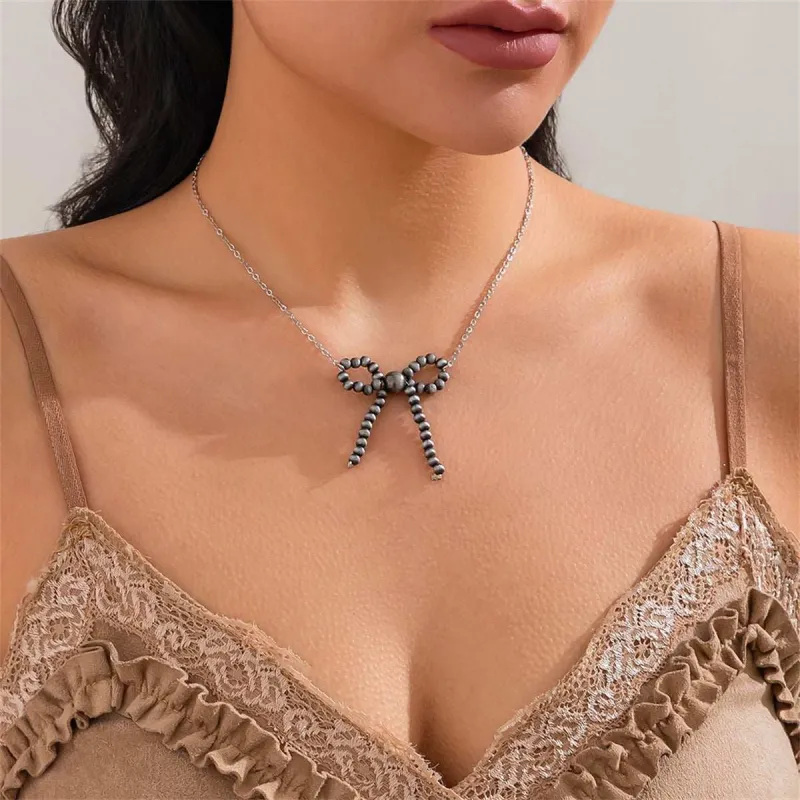 Dark Resin & Silvertone Bow Pendant Necklace made by Zulily