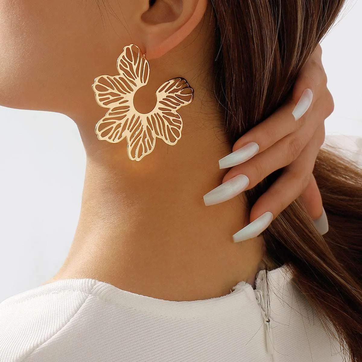 Goldtone Cutout Flower Huggie Earrings sold by Zulily