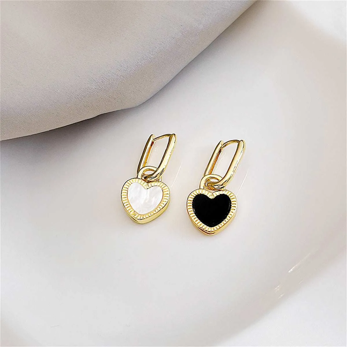 White & Black Heart Huggie Earrings sold by Zulily product image thumbnail 2