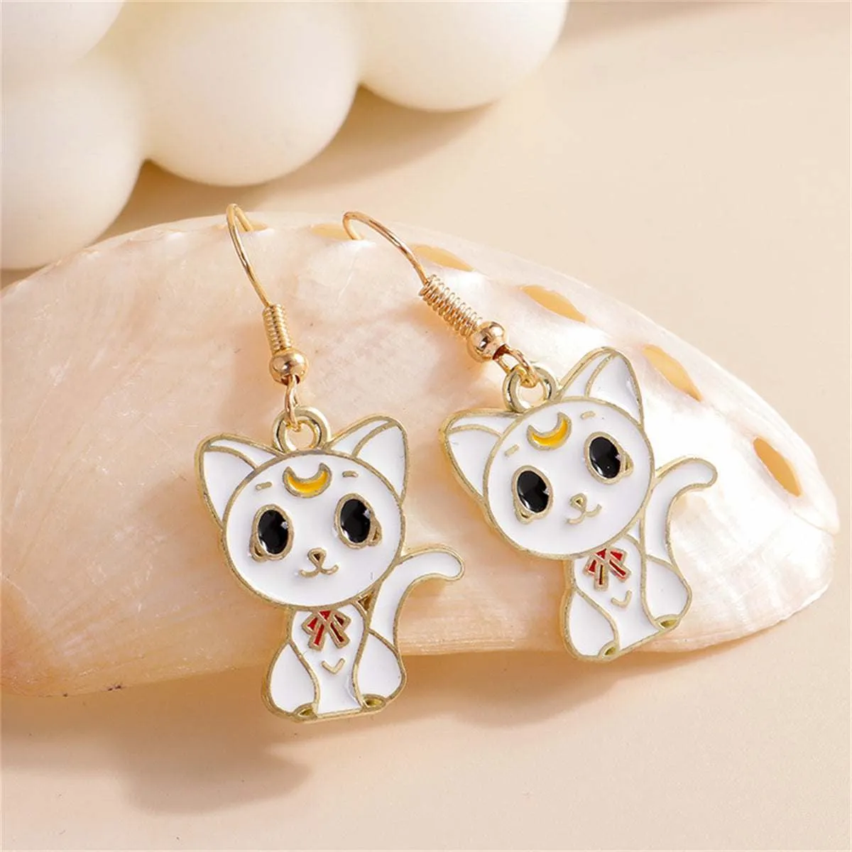 White Enamel & Goldtone Cat Drop Earrings sold by Zulily