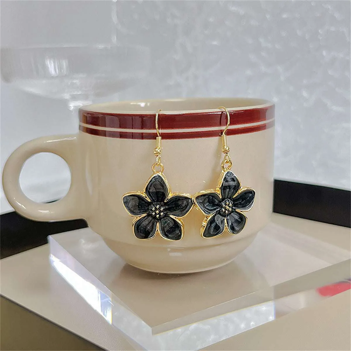 Black Enamel & Goldtone Flower Drop Earrings sold by Zulily