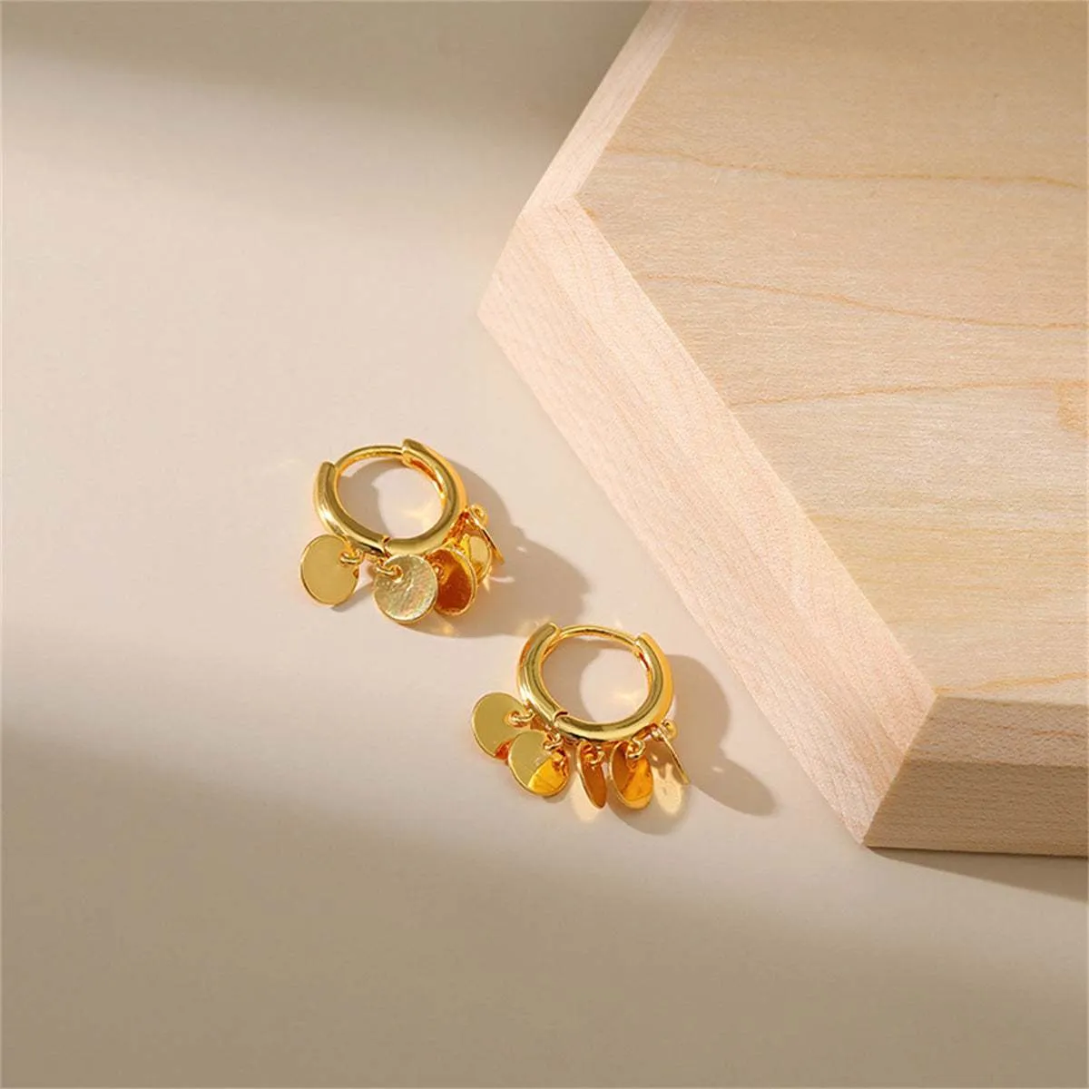 Goldtone Disc Tassel Huggie Earrings sold by Zulily product image thumbnail 5