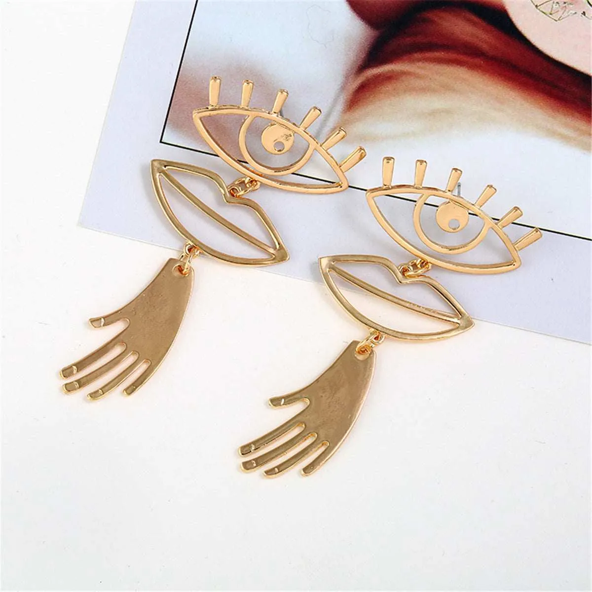 Goldtone Eye & Lip Drop Earrings sold by Zulily product image thumbnail 3