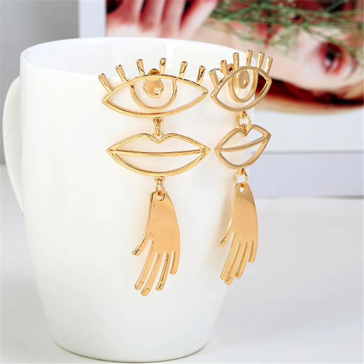 Goldtone Eye & Lip Drop Earrings sold by Zulily product image thumbnail 2
