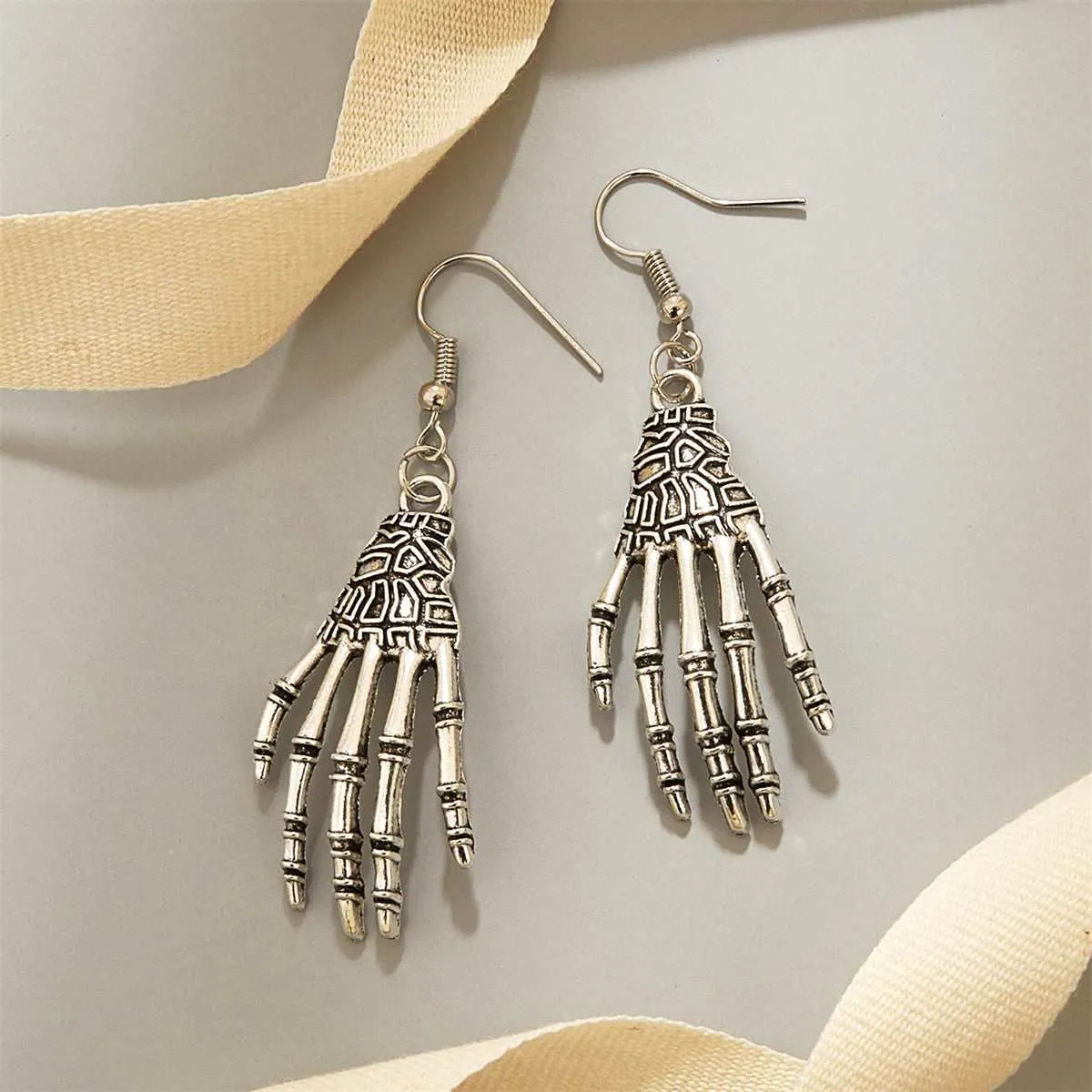 Silvertone Skeleton Hand Drop Earrings sold by Zulily