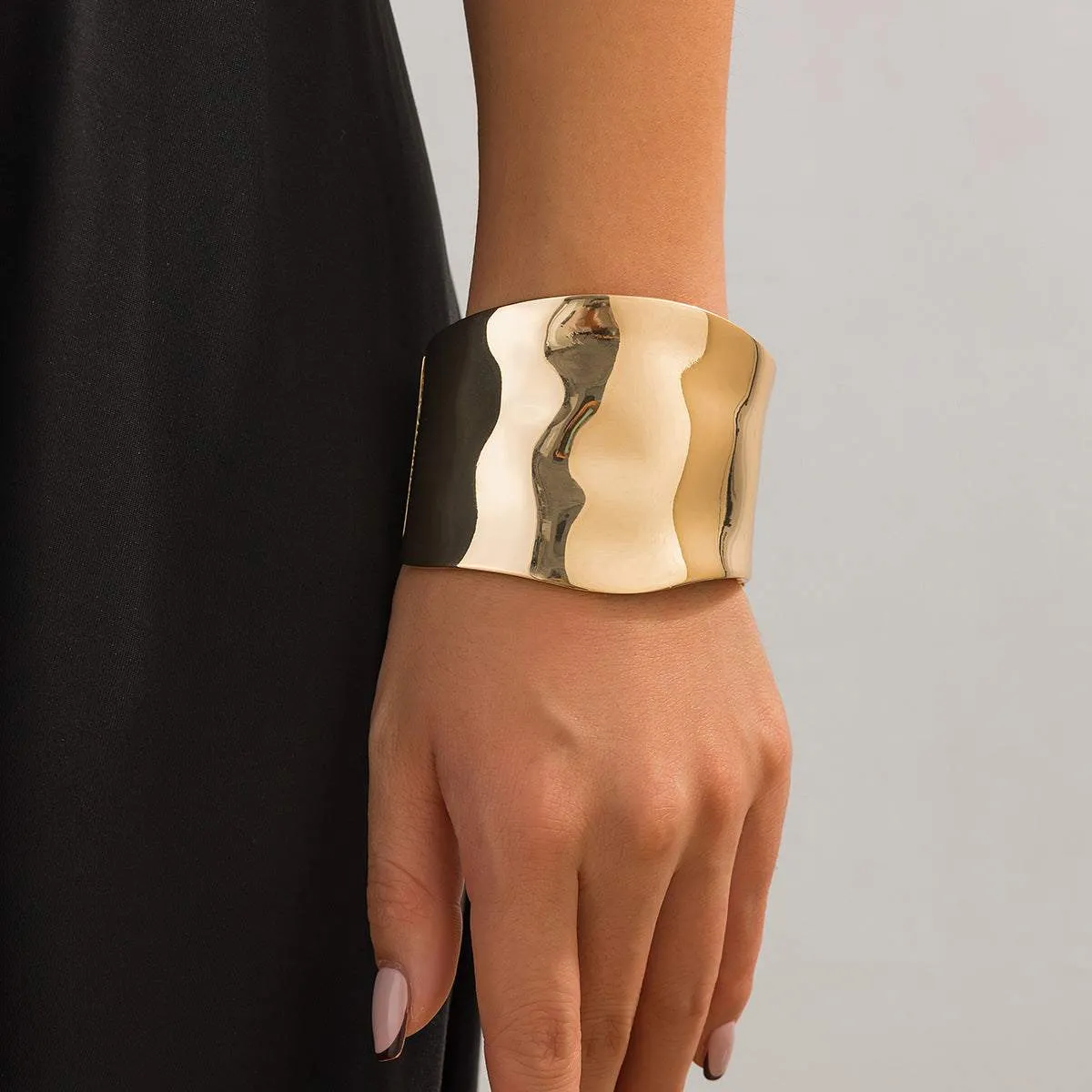 Goldtone Bright Curved Surface Bangle sold by Zulily