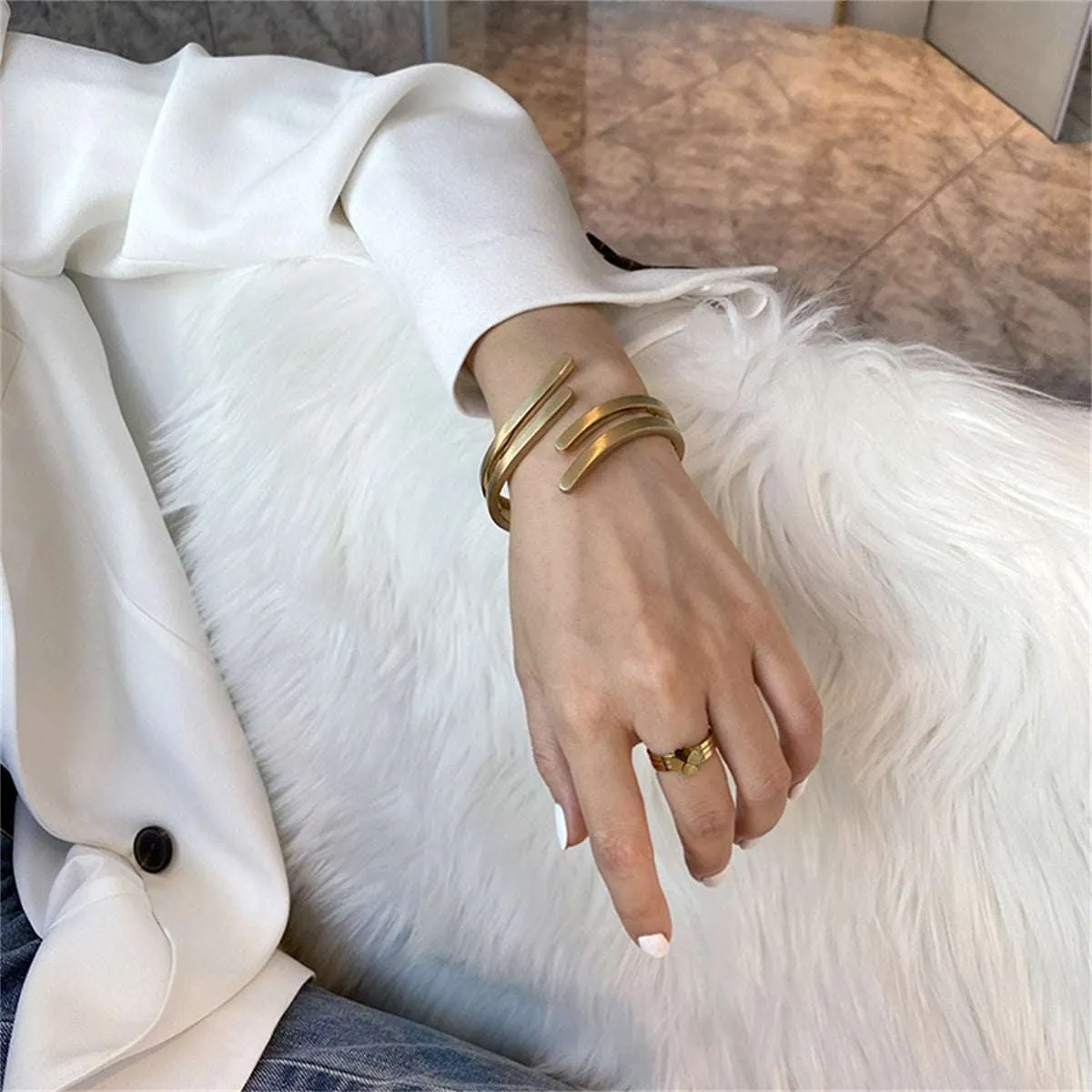 Goldtone Wing Open Bypass Coil Bracelet sold by Zulily product image thumbnail 3