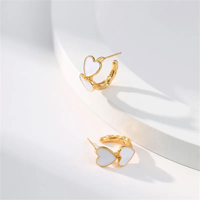 White Enamel & Goldtone Heart Huggie Earrings made by Zulily