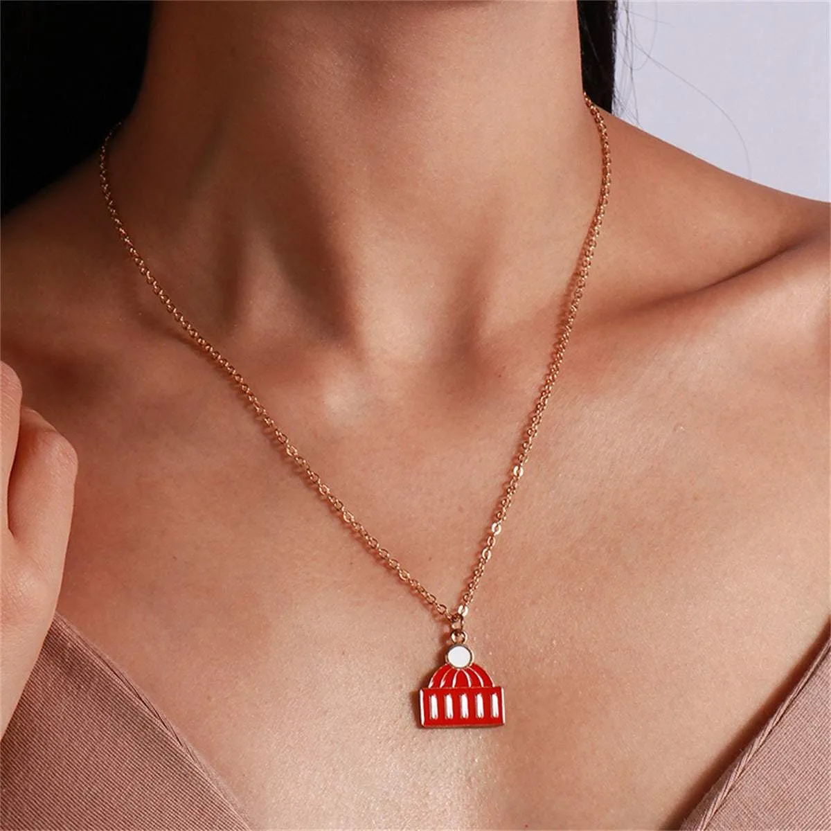 Red Enamel & Goldtone Hat Pendant Necklace sold by Zulily