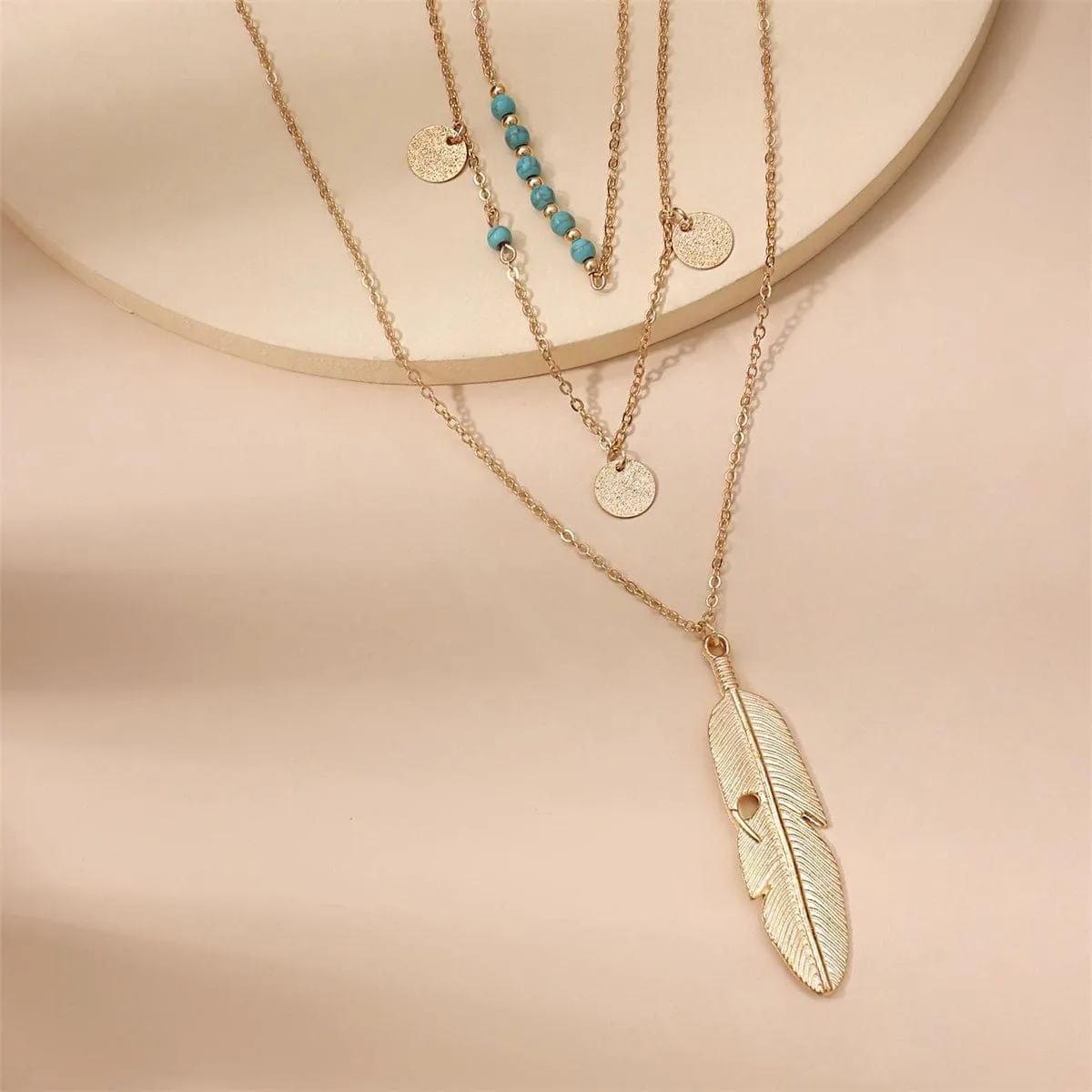 Turquoise & Goldtone Feather Layered Pendant Necklace sold by Zulily