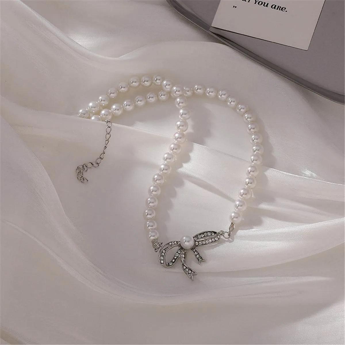 Cubic Zirconia & Pearl Beaded Bow Pendant Necklace sold by Zulily