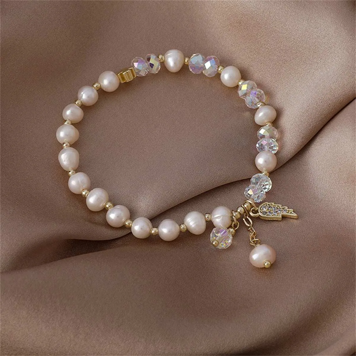 Pearl & Cubic Zirconia Goldtone Wing Charm Stretch Bracelet sold by Zulily