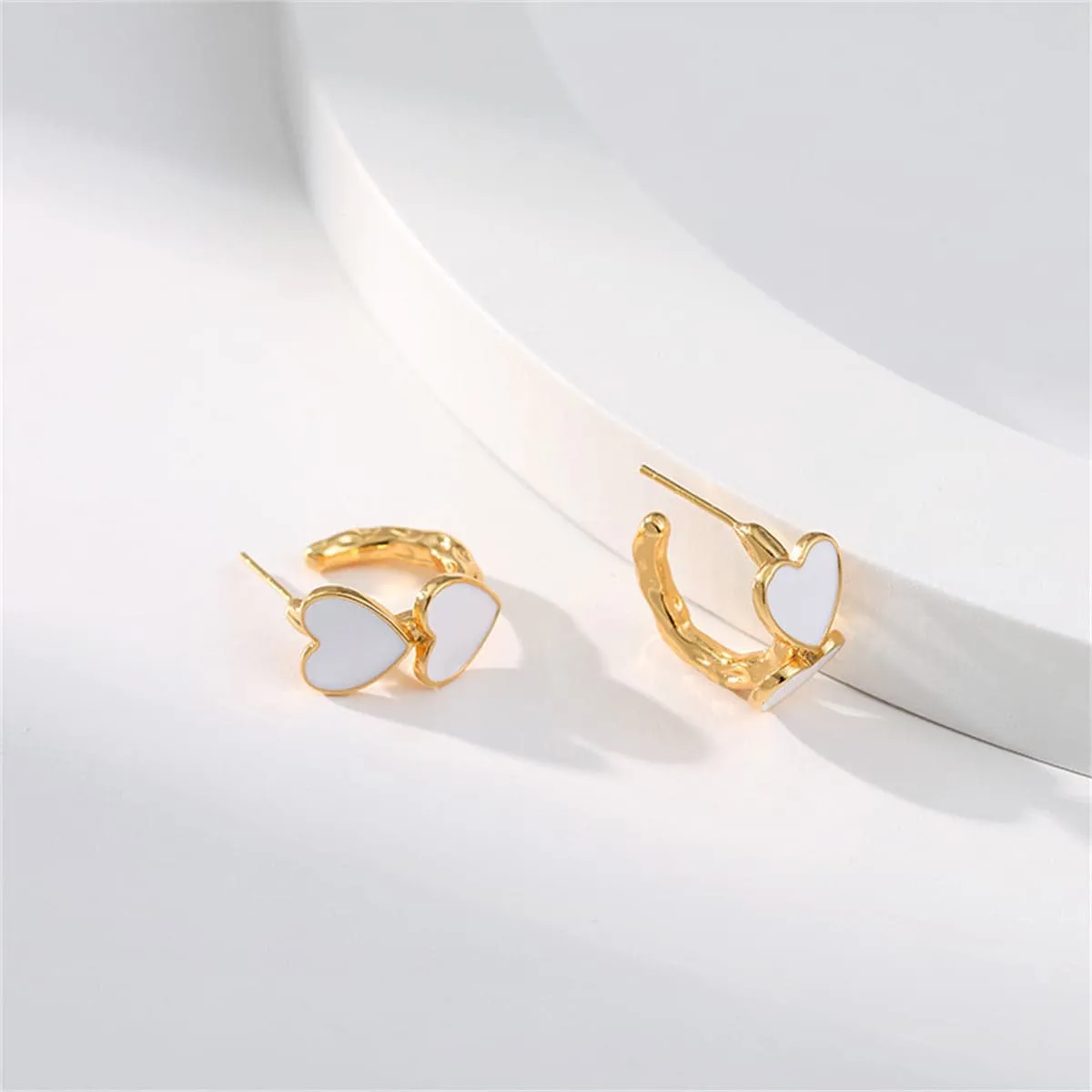 White Enamel & Goldtone Heart Huggie Earrings sold by Zulily product image thumbnail 3