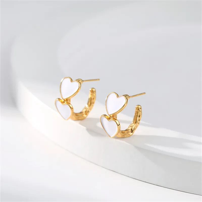 White Enamel & Goldtone Heart Huggie Earrings made by Zulily