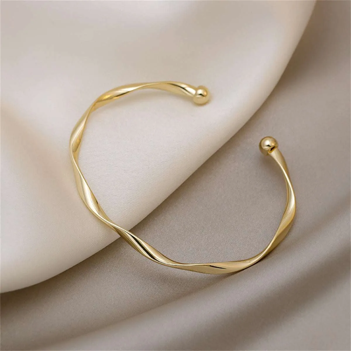 Goldtone Curved Waves Cuff sold by Zulily