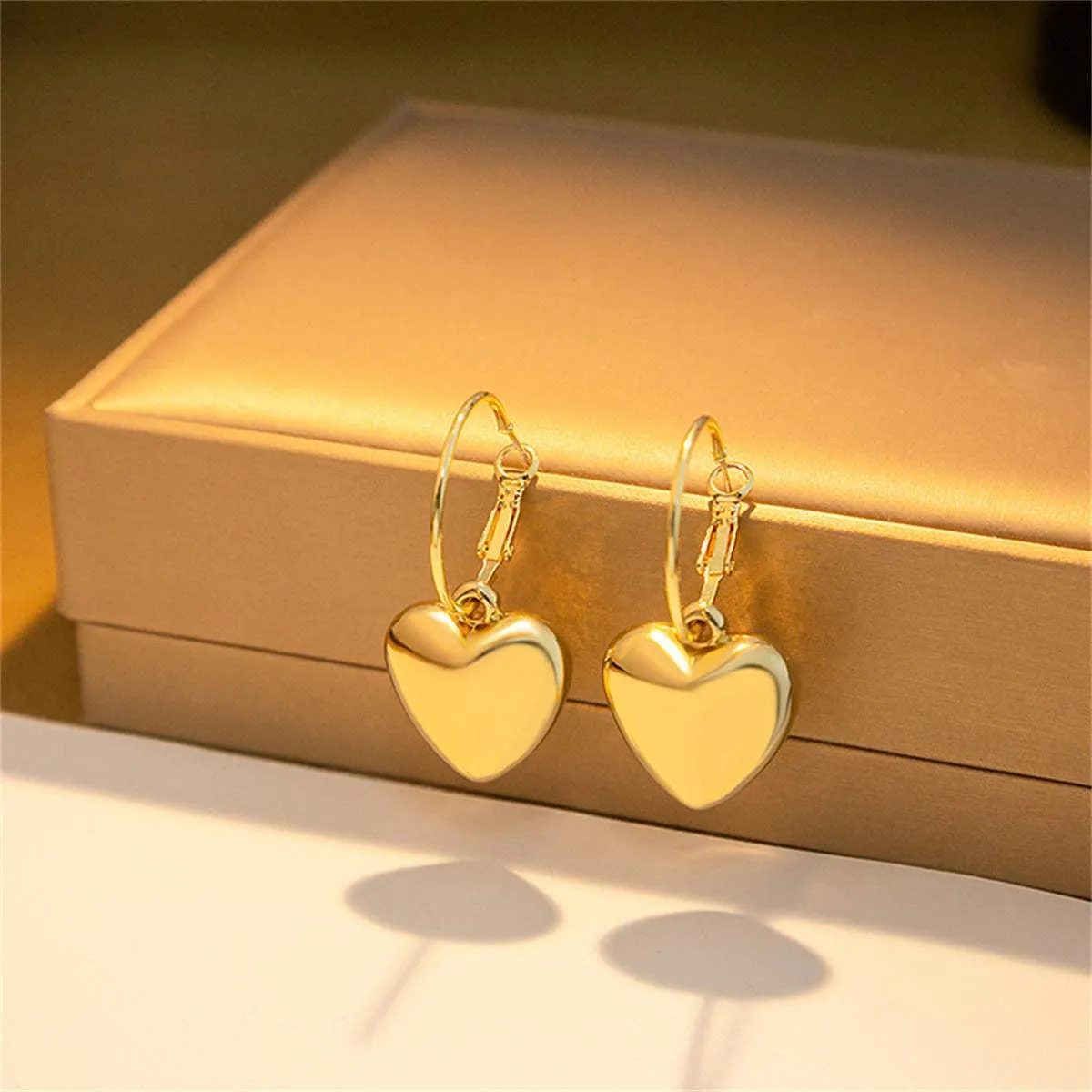Goldtone Heart Huggie Earrings sold by Zulily product image thumbnail 3