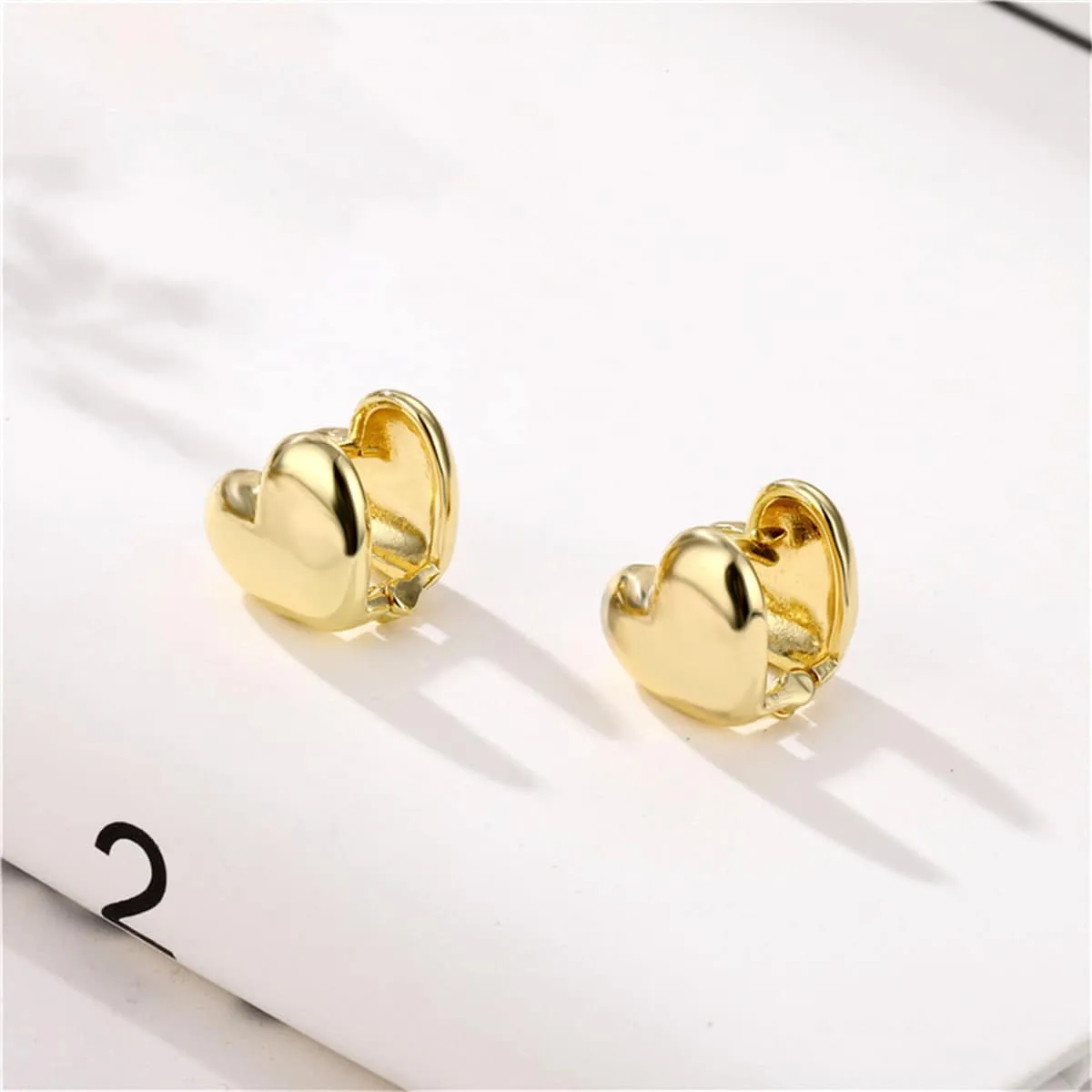 Goldtone Heart Huggie Earrings sold by Zulily product image thumbnail 4
