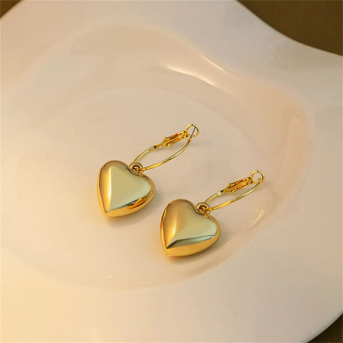 Goldtone Heart Huggie Earrings sold by Zulily product image thumbnail 2