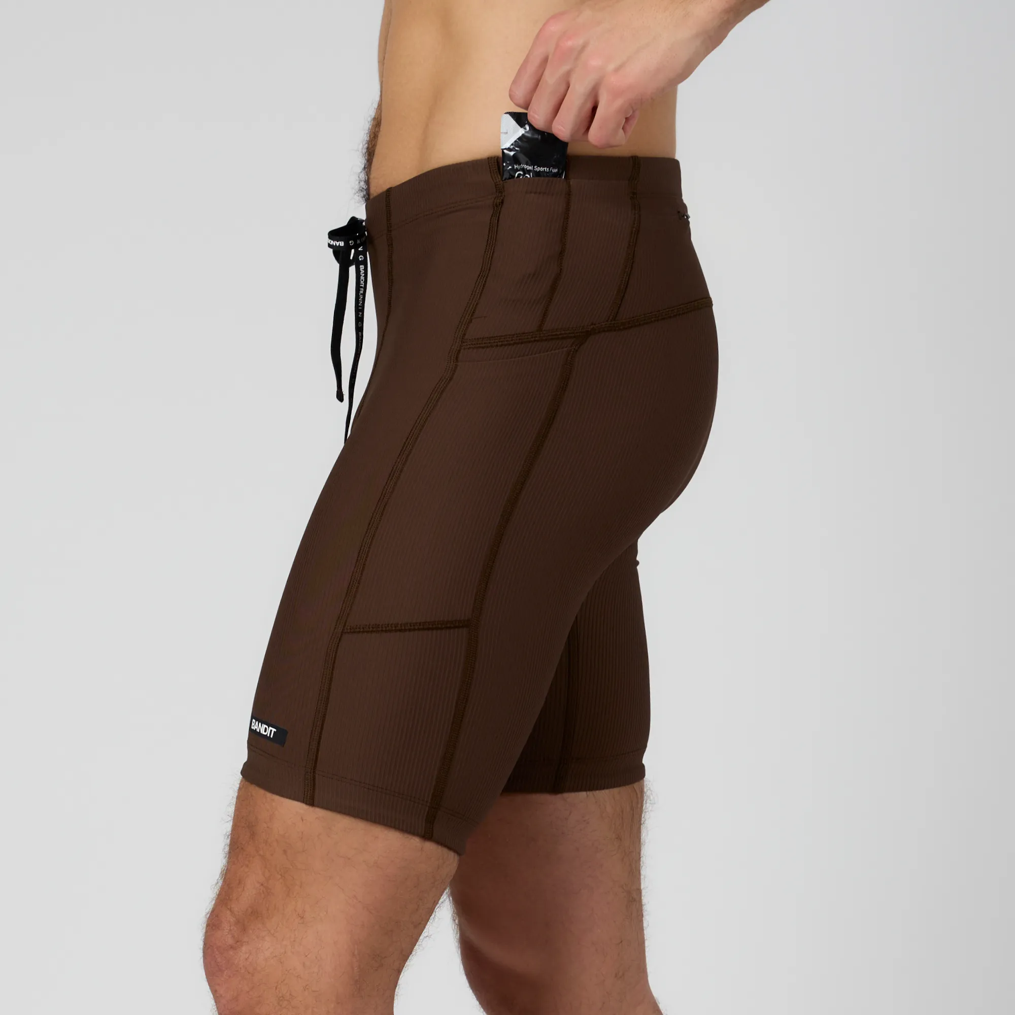 Cadence™ Next Gen 7 Pocket Half Tights - Umber sold by Bandit Running