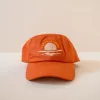 I love it here cap sold by Cai & Jo
