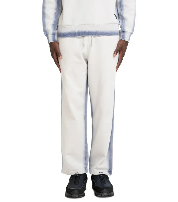 The Trilogy Tapes Overdye Open Hem Jogger Grey Blue made by Somewhere